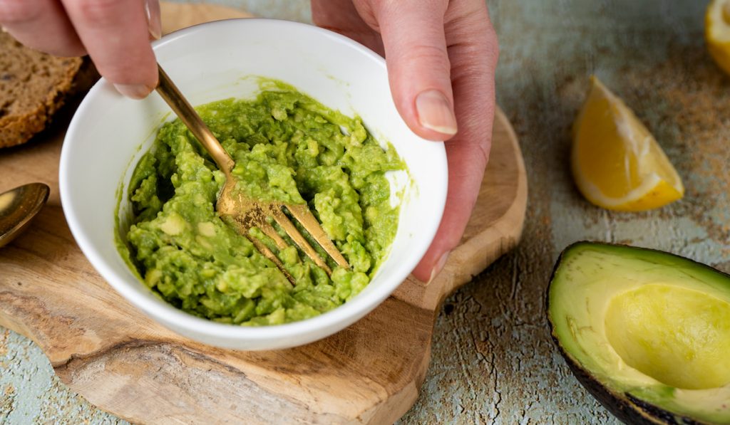 mashing avocado