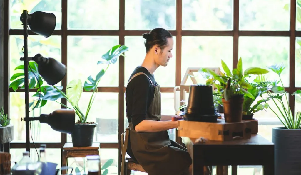 young man caring for plants