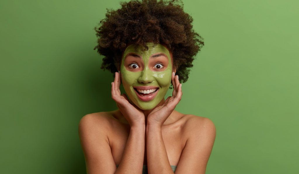 woman with avocado face mask